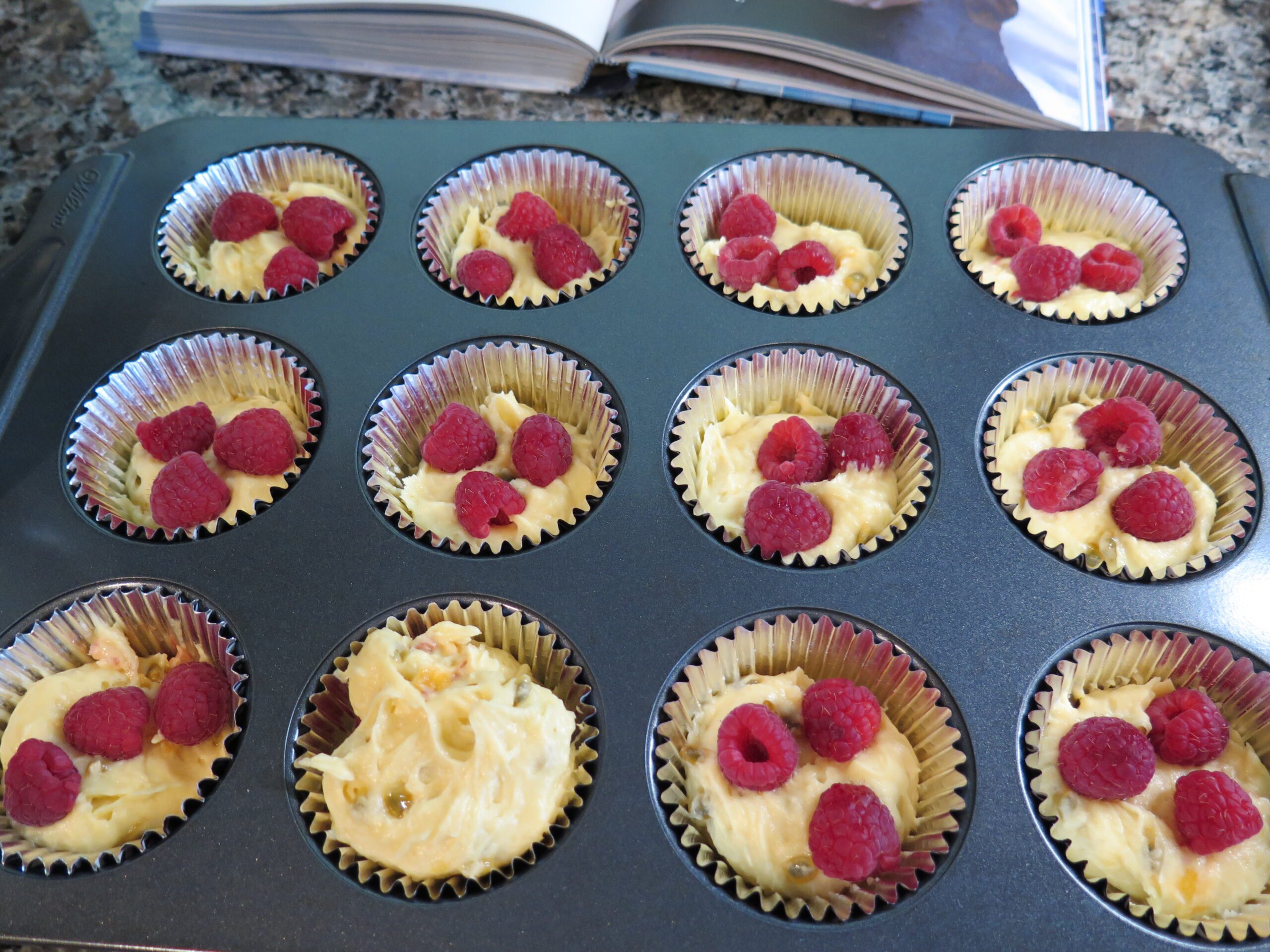 raspberry and passion fruit muffins - half filled
