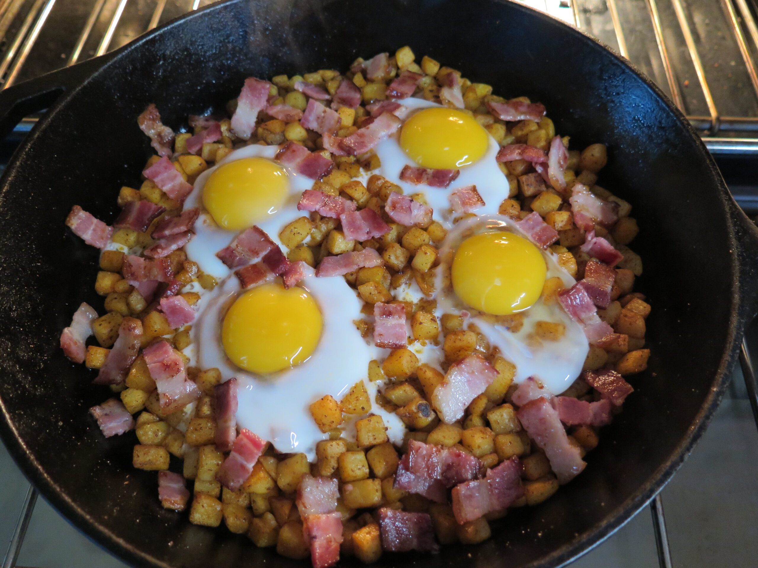 Add bacon to the cooked eggs and hash browns