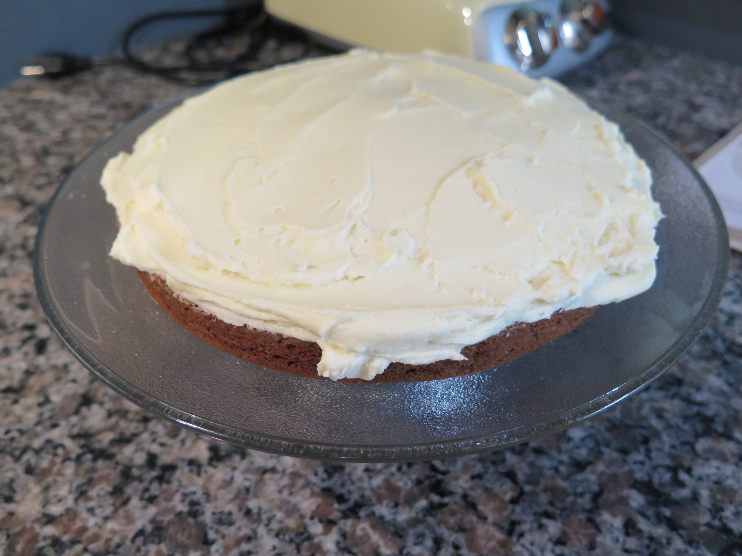 First layer of carrot cake frosted