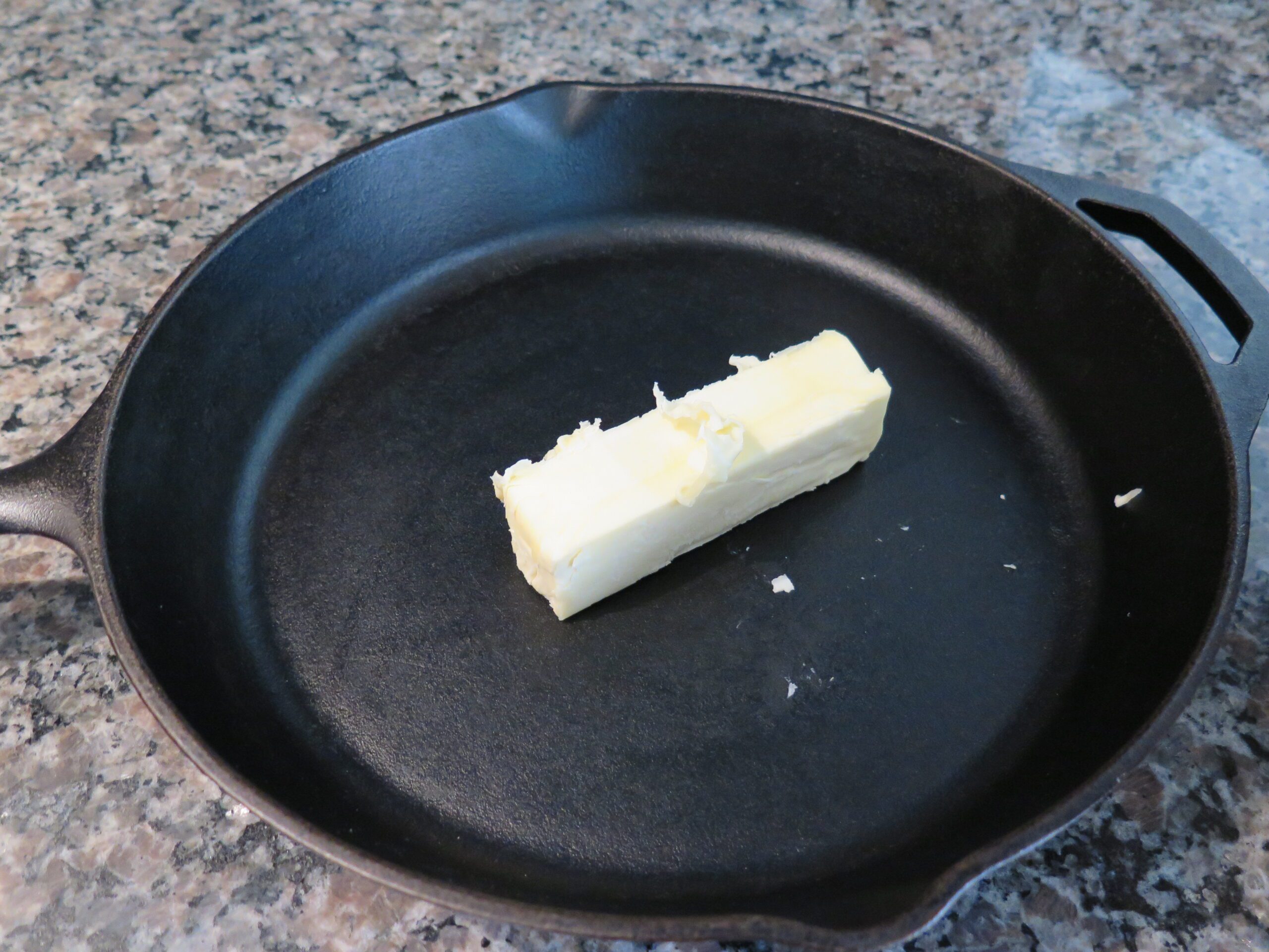 stick of butter in lodge cast iron pan