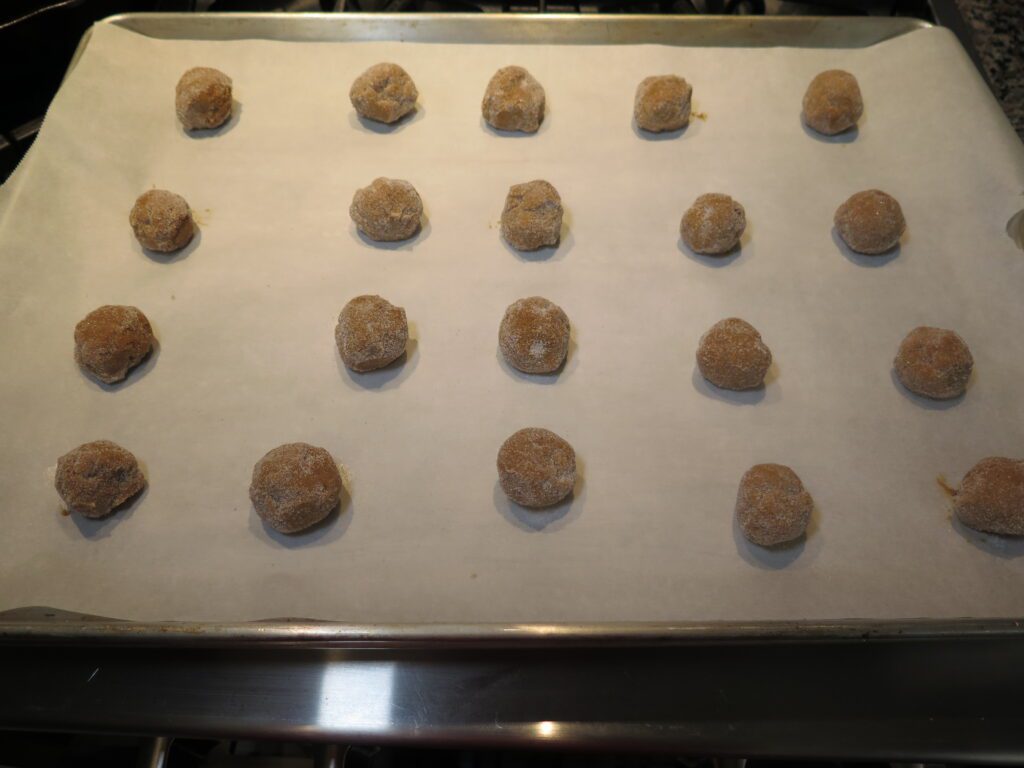 Rolled chewy molasses cookies ready for oven