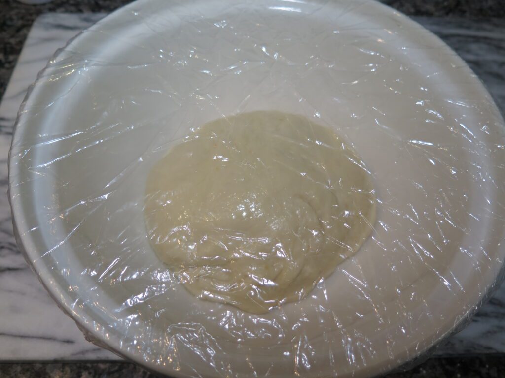 Dough placed in a lightly greased bowl and covered