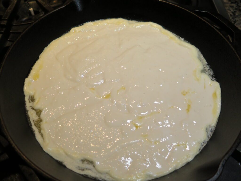 Pour cobbler filling into melted butter