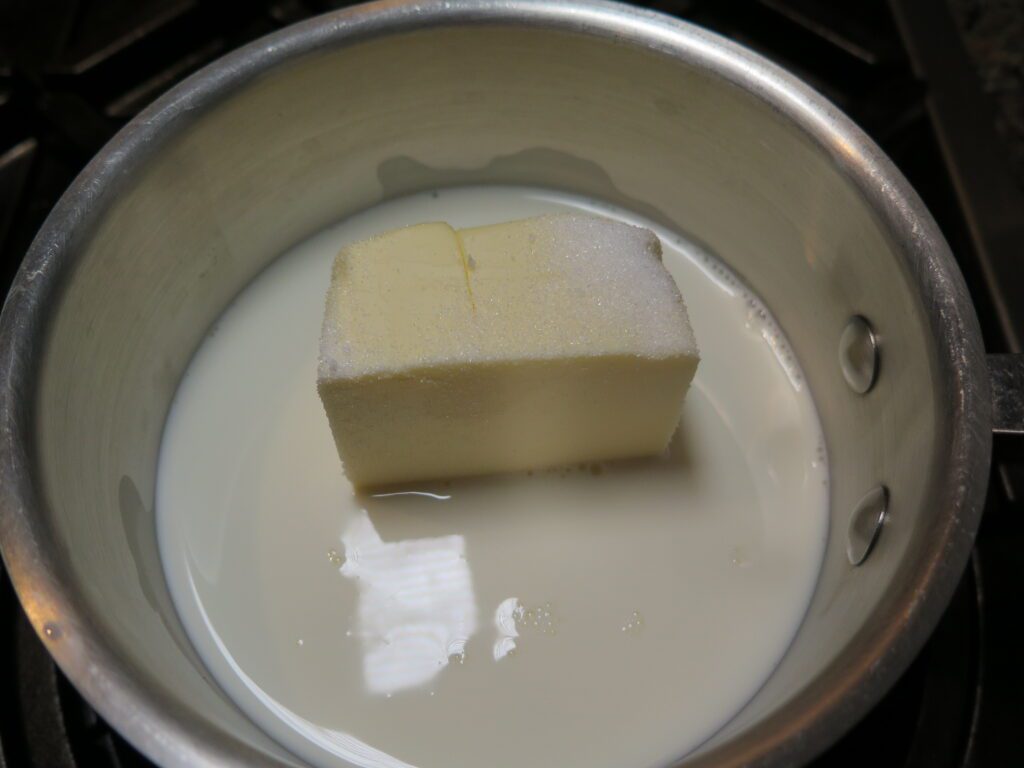 Milk, butter and sugar in sauce pot
