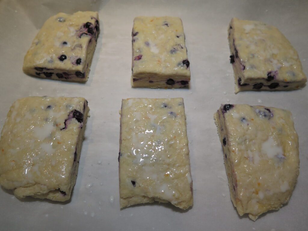 move slices to baking sheet and brush with milk